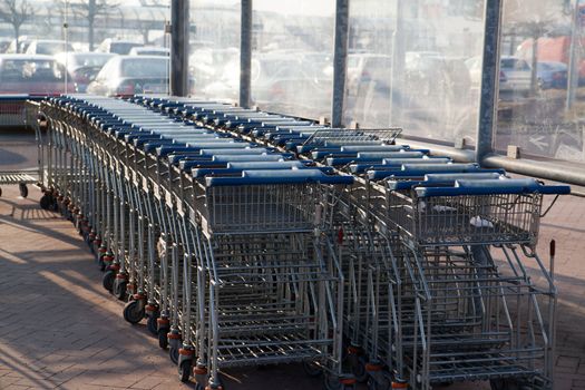 Row of empty shopping carts at the supermarket
