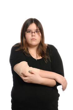 A teenage girl holding her injured elbow with no expression on her face, isolated against a white background.