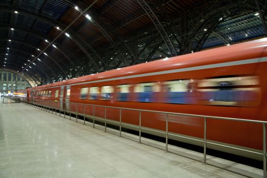 Fast train departing from the station motion blur
