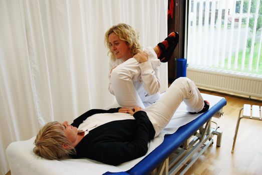 SAALFELDEN, AUSTRIA - AUGUST 30: physical therapist exercising with female rheumatism patient on August 30, 2007 at rehabilitation center in Saalfelden, Austria.