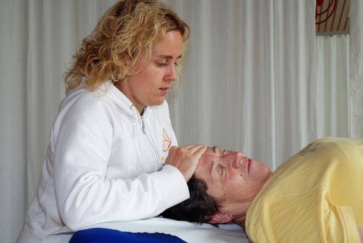 SAALFELDEN, AUSTRIA - AUGUST 30: physical therapist exercising with senior rheumatism patient on August 30, 2007 at rehabilitation center in Saalfelden, Austria.