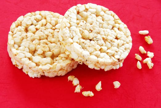 two round rice cakes over red background