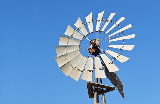 windmill against blue sky copy space