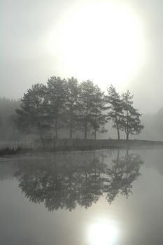 Morning mist with sun reflection in the water.  