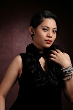 portrait of a pretty asian lady in dark background
