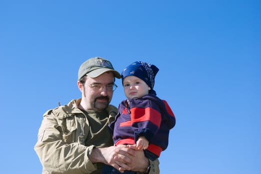 Family under blue sky.father and son