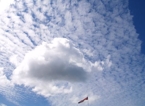 Clouds and norwegian flag in bottom of picture