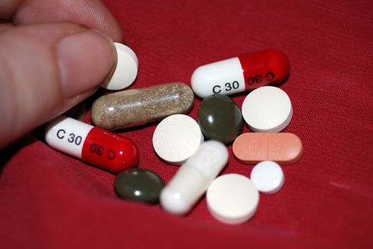 Taking an array of pills, capsules and tablets.