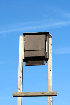 A bat house against blue sky