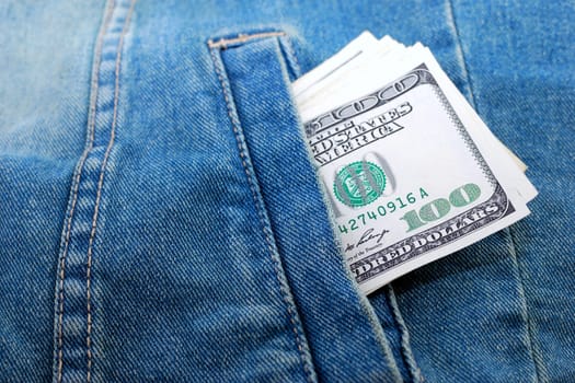 Lot of dollars in a pocket of jeans jacket.