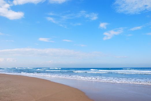 Waves running on sandy coast of Mediterranean sea