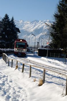 Small regional train in winter panorama of zell am see, austria.