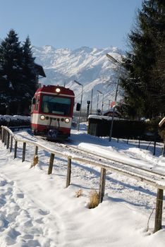 Small regional train in winter panorama of zell am see, austria.