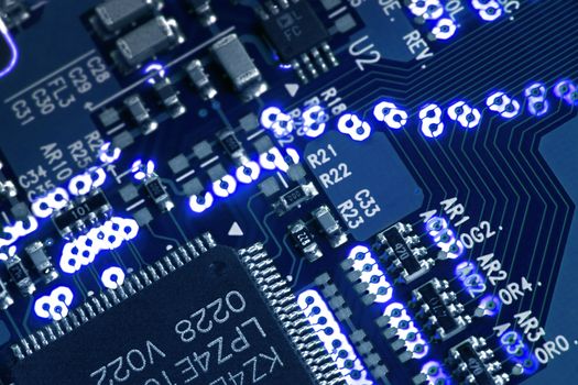 Blue glowing circuit board macro detail