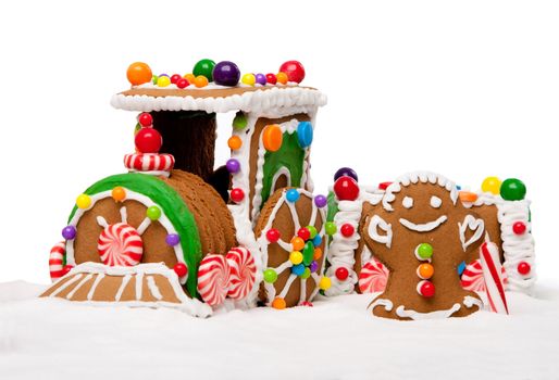 Gingerbread Polar Express Train and happy man for Christmas covered with snow and colorful candy on a winter landscape, isolated.