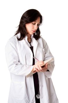 Female doctor physician in white coat and stethoscope writing medical prescription note in patient chart, isolated.