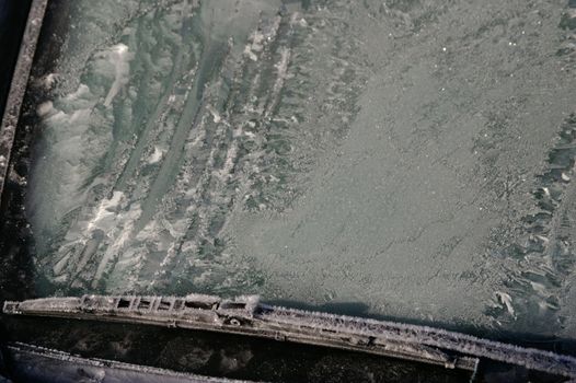 car windshield covered with ice and snow