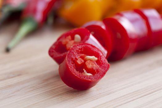 Close up of slice of hot pepper in cutting board.