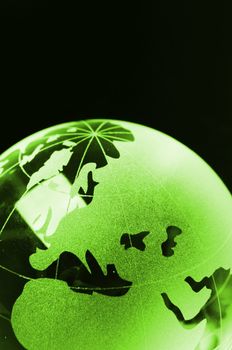 glass globe on black background showing business or environment concept with copyspace