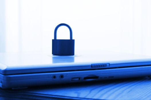 notebook and padlock showing internet or data security concept in blue