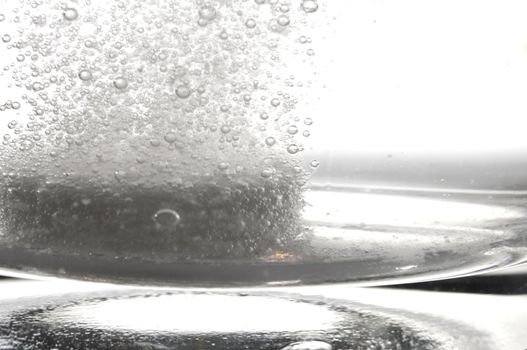 tablet or pain killer in a glass of water with copyspace