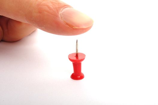 risk concept with finger over risky pin