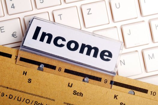 income word on business folder showing finance financial or earnings concept