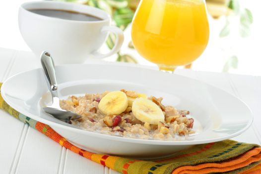 Bowl of nutritious oatmeal with bananas and nuts.