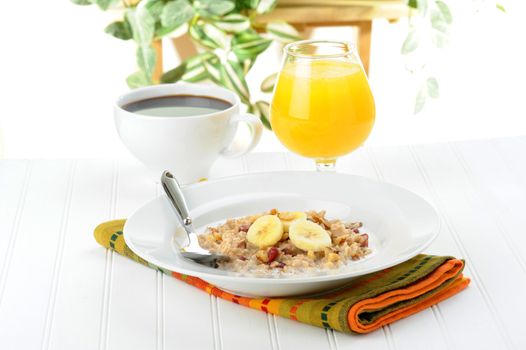 Delicious breakfast consisting of oatmeal, orange juice and coffee.