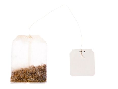 A tea bag with a blank labek on a string. Isolated over white with clipping path.
