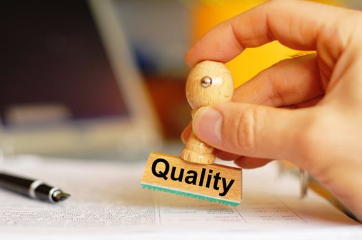 quality concept with stamp in business office and copyspace