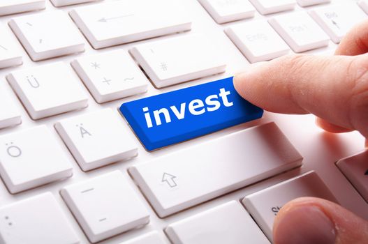 invest key on keyboard showing financial business investment concept