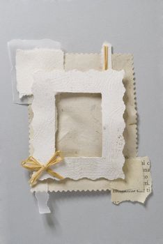 Paper frame made of pieces of paper with a little bow