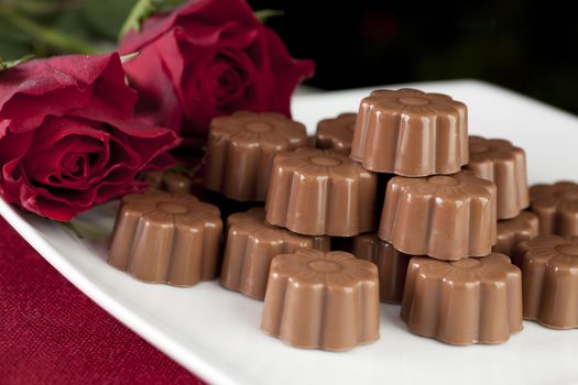 Romantic gift of red roses and milk chocolates.