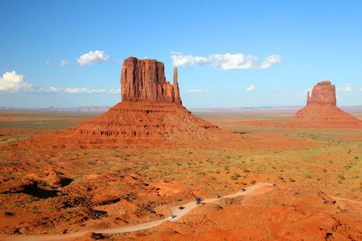 Left and Right Mittens in Monument Valley, Arizona dwarf the vehicles in the foreground