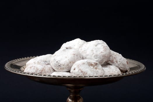 White Tea Cakes on a sterling silver tray on black background