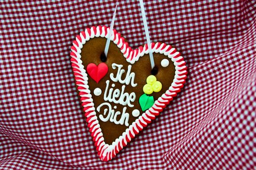 gingerbread Oktoberfest heart saying "I love you" on bavarian red checkered cloth
