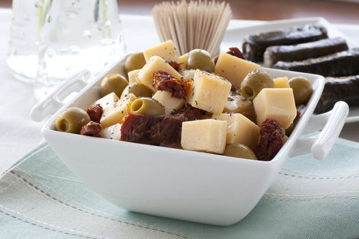 Cheese, sun dried tomatoes and stuffed olives appetizers.