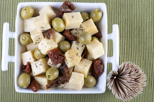 Cheese, sun dried tomatoes and stuffed olives appetizers.