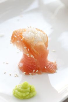 Sushi:  Fresh salmon filled with rice and sesame seeds, served with wasabi.