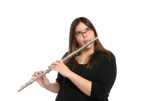 A young brunette girl is playing the flute, isolated against a white background.