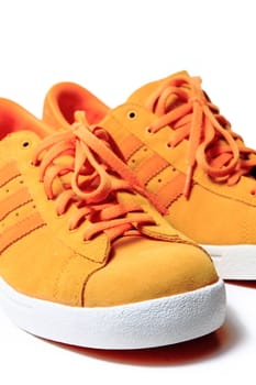 Orange sport shoe close up, isolated on white