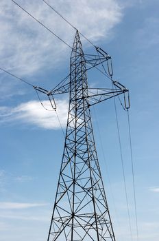 High voltage electric pillar against blue sky