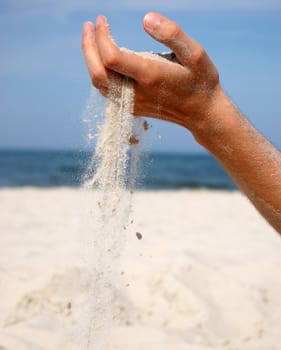 Concept photo of sand falling from the man's hand. 