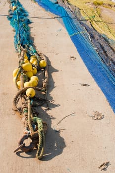 Trawl fishing nets and tackle drying on a pier