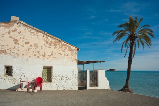 Traditional whitewashed Mediterranean house  located on a quiet beach