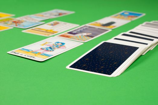 Tarot card spread reading on a green table