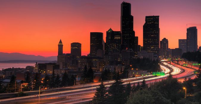 Seattle downtown glowing red in hot summer, freeway traffic in foreground