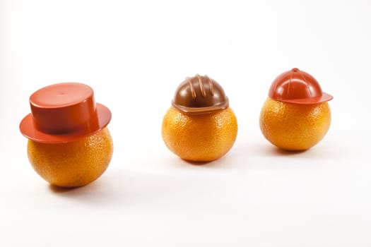 fresh tangerines in the headgear on a light background