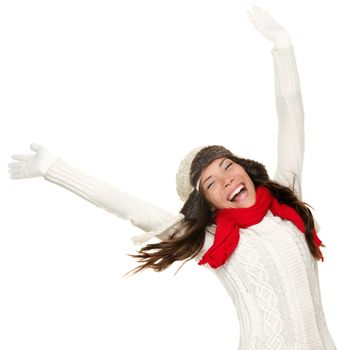 Winter fun woman winner and success concept. Cheering happy ecstatic female model with arms up celebrating winning something. Multicultural Caucasian Asian winter girl isolated on white background.